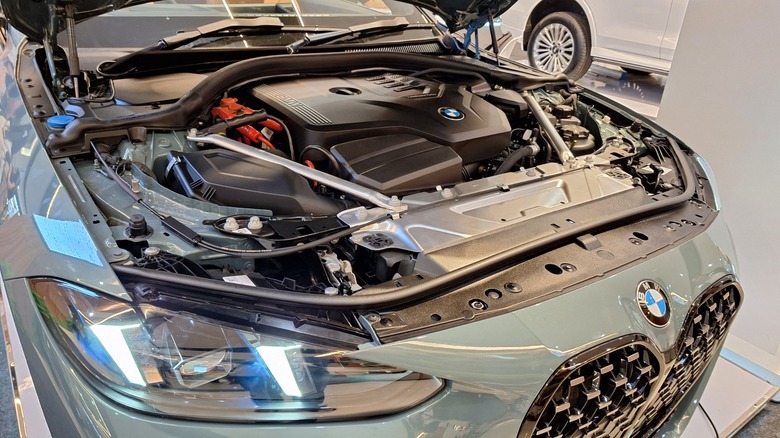 a turbocharged BMW engine in engine bay of green car