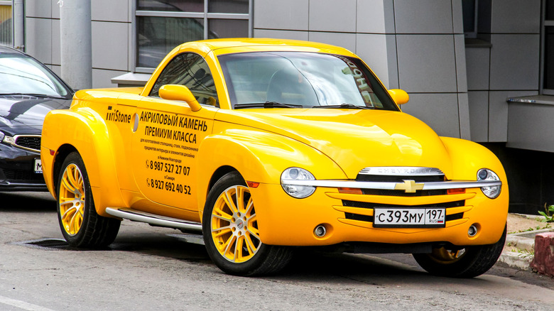 Yellow Chevy SSR parked on street