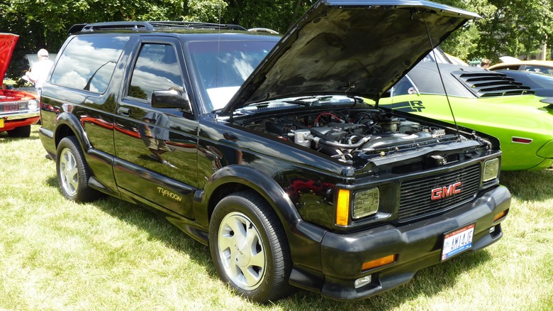 A black 1993 GMC Typhoon on display at a car show.