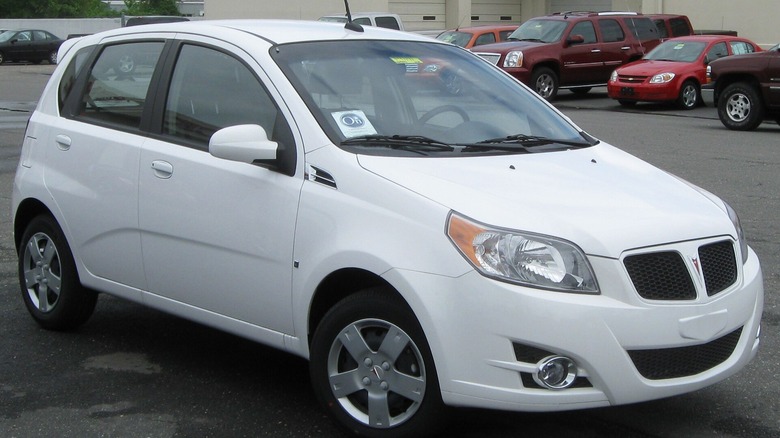 A white Pontiac G3, front-right three-quarter view.