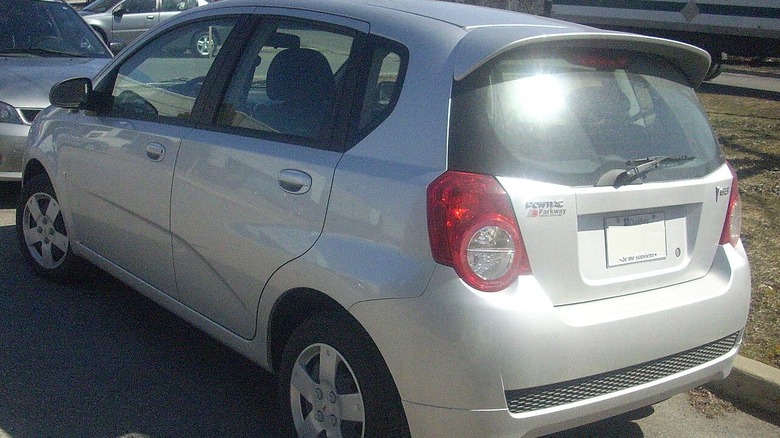 A silver Pontiac G3, rear-left three-quarter view.