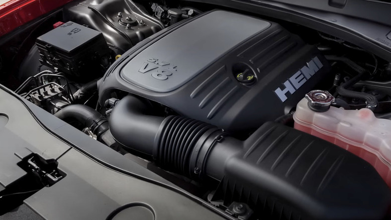 Chrysler 5.7-liter HEMI engine in vehicle with engine cover in place and full coolant reservoir