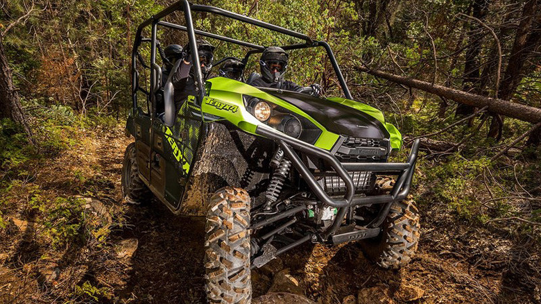 Kawasaki Teryx 4 on muddy trail in woods