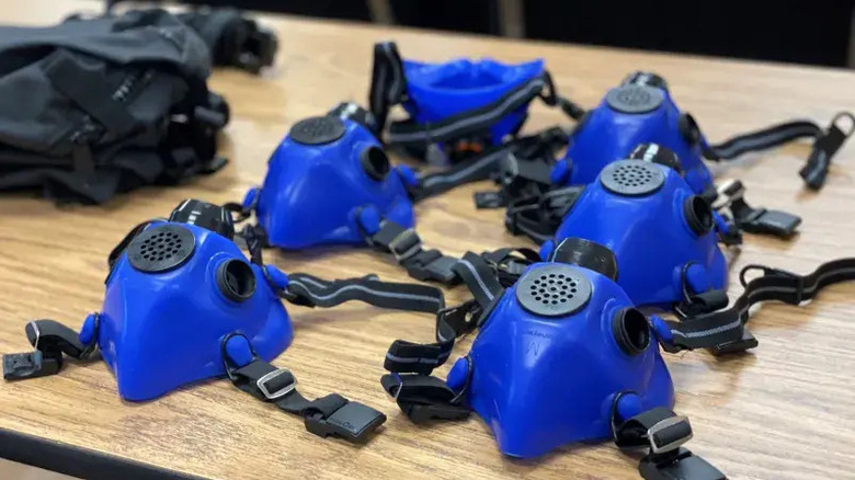 Blue and black Wildland firefighter respirator masks on a table