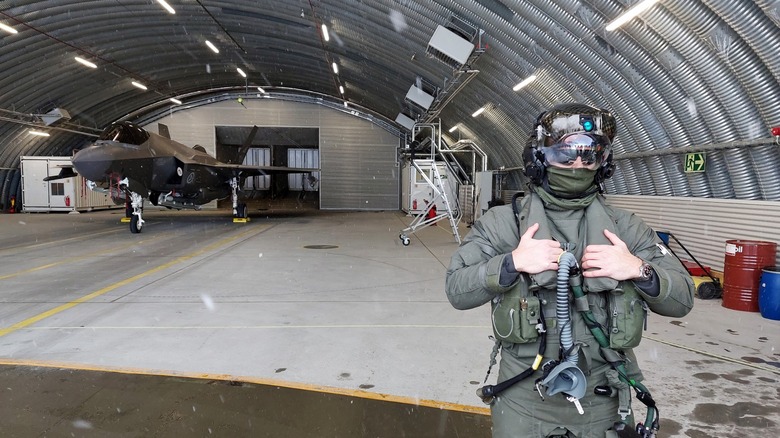 F-35 fighter jet pilot with F-35 jet