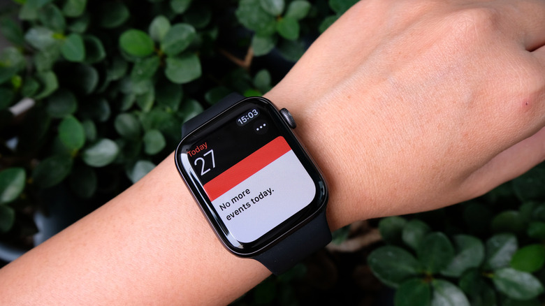 Person wearing Apple Watch with calendar app displayed