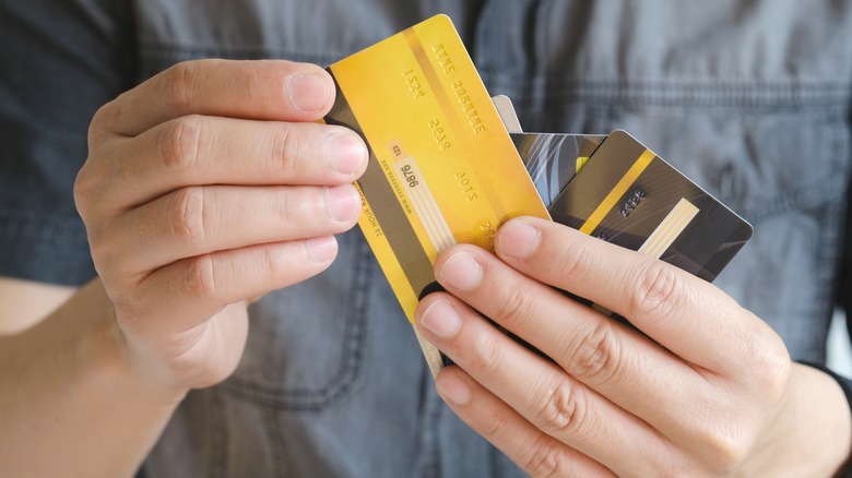 person holding credit cards