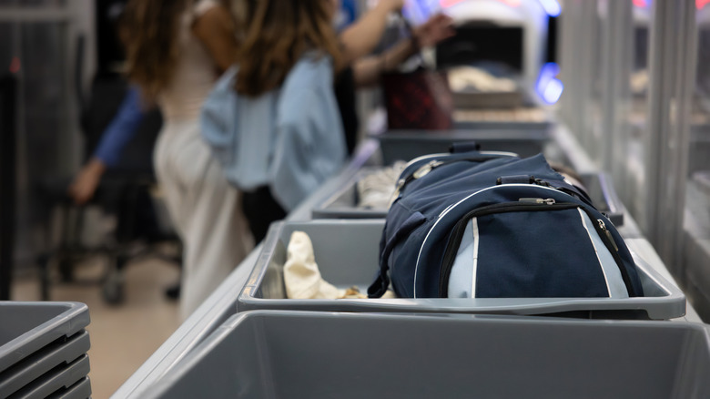 A bag rolling through a TSA checkpoint