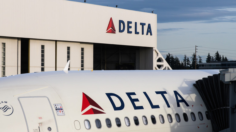 Delta logo on airplane and boarding terminal