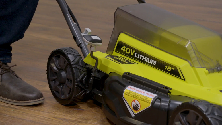 Ryobi push mower with the height adjustment lever in the back wheel