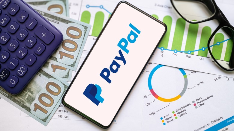 Paypal logo, currency, calculator, and smartphone