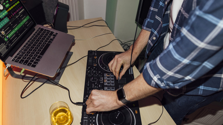 Man DJs at house party