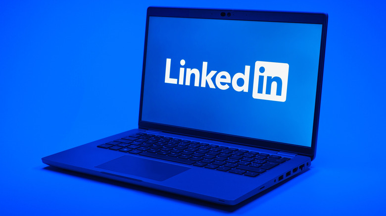 A blue laptop showing the LinkedIn logo on a blue background