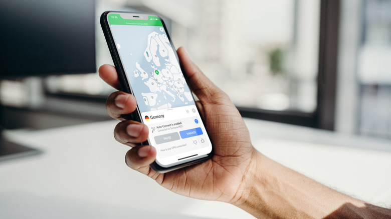 Hand holding iPhone with NordVPN