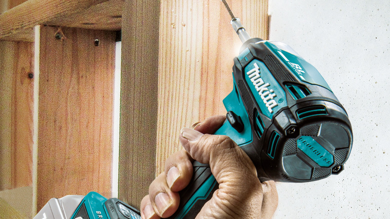 Person using a Makita impact driver