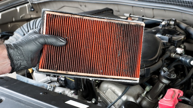 person holding dirty engine air filter