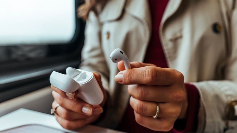 woman taking out airpod