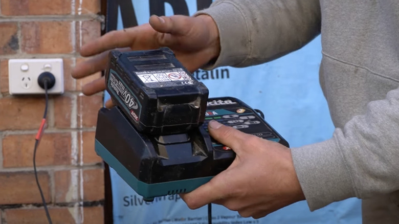 Person showing how to use Makita 40 volt battery charger