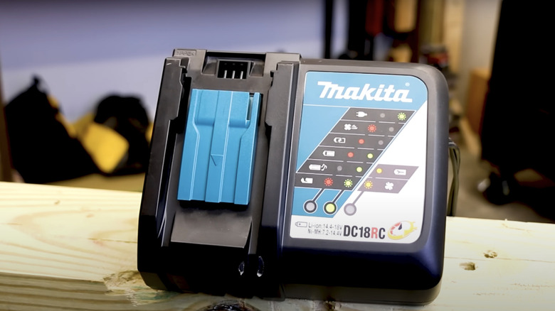 Makita 18 volt rapid charger sitting on a piece of lumber