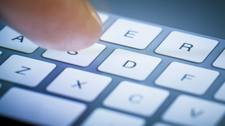 closeup of finger on smartphone keyboard