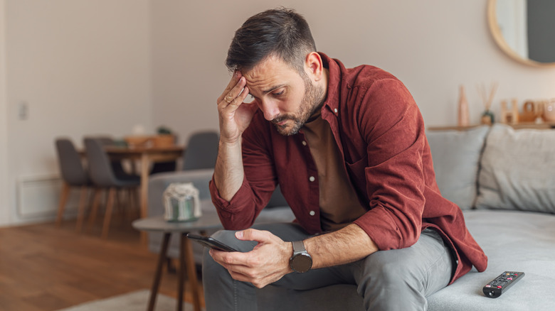 Man frustrated with smartphone