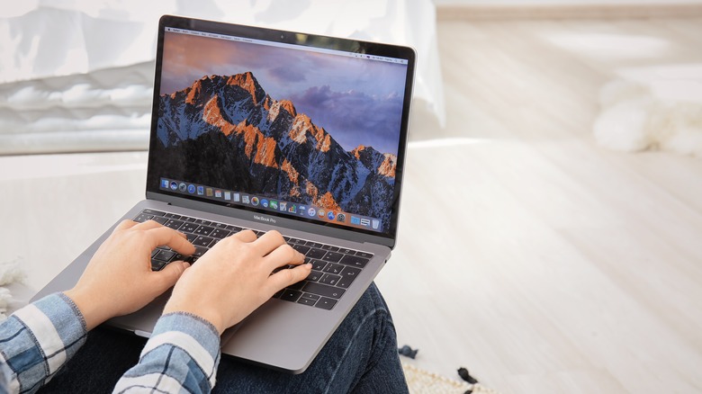 person typing on MacBook Pro