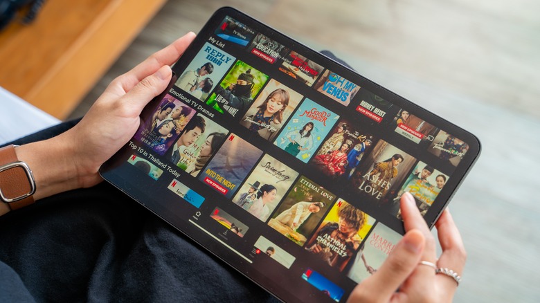 Person browsing Netflix TV shows on an iPad