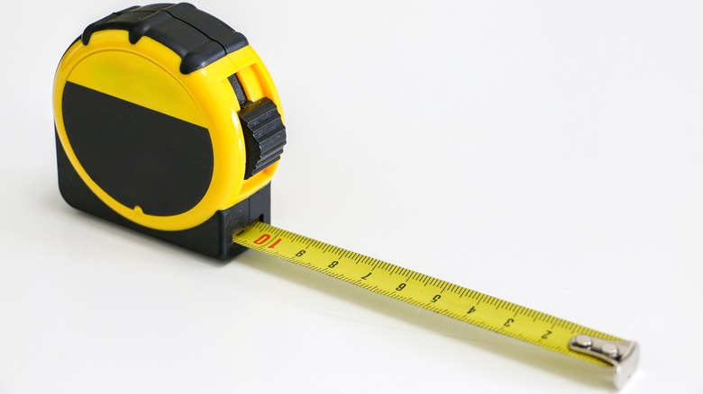 A yellow and black retractable tape measure with a yellow tape