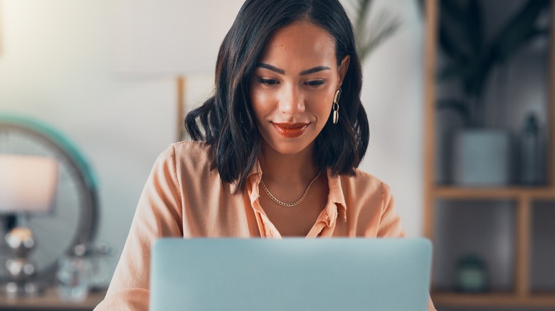 A woman using a laptop.