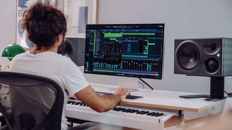 music producer uses Cubase at desk