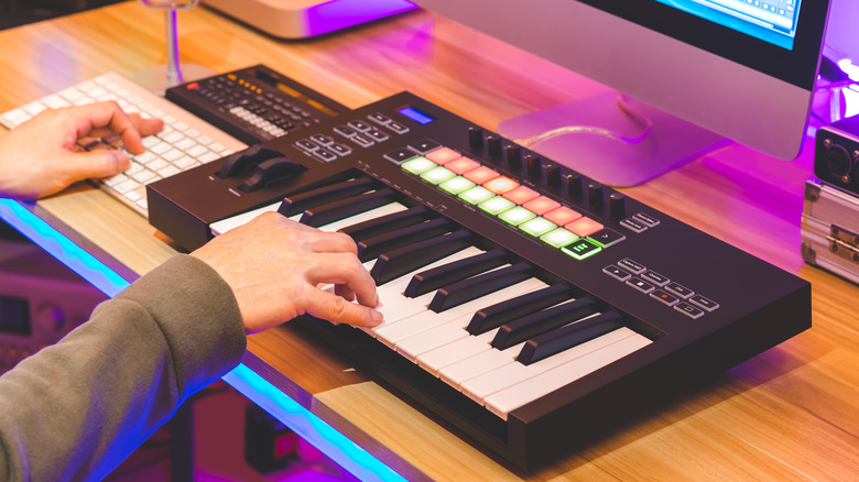 music producer uses MIDI keyboard