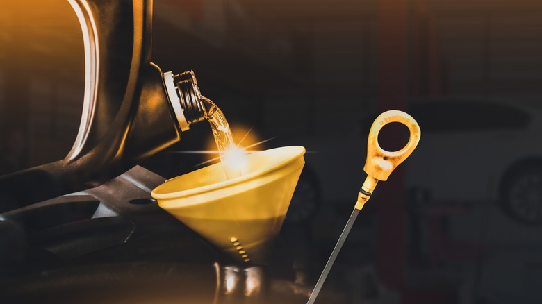 Oil being poured into funnel