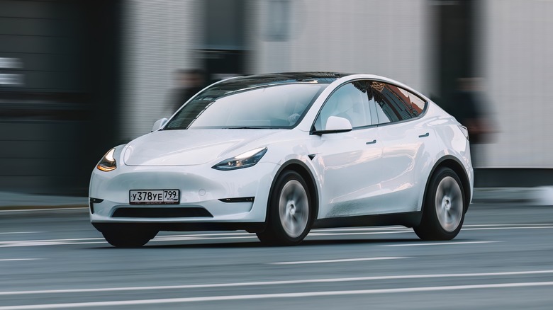 Silver Tesla Model Y driving