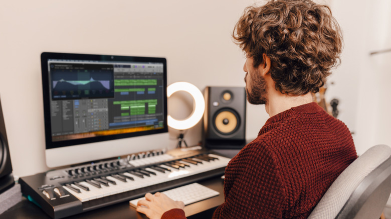 Man using GarageBand DAW on Mac