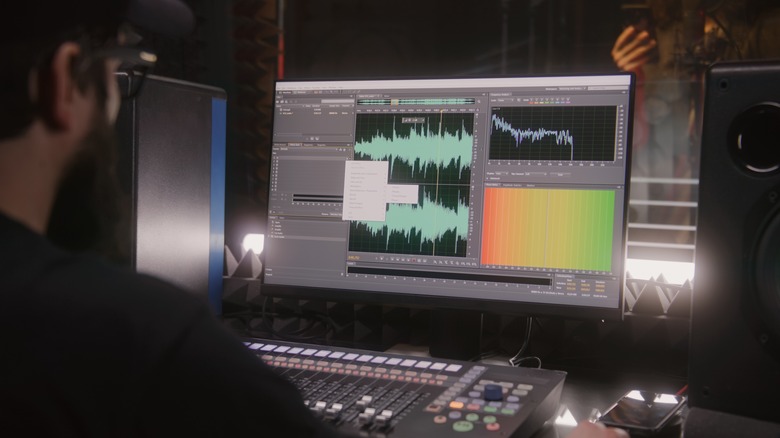 Person editing soundwave in DAW on PC