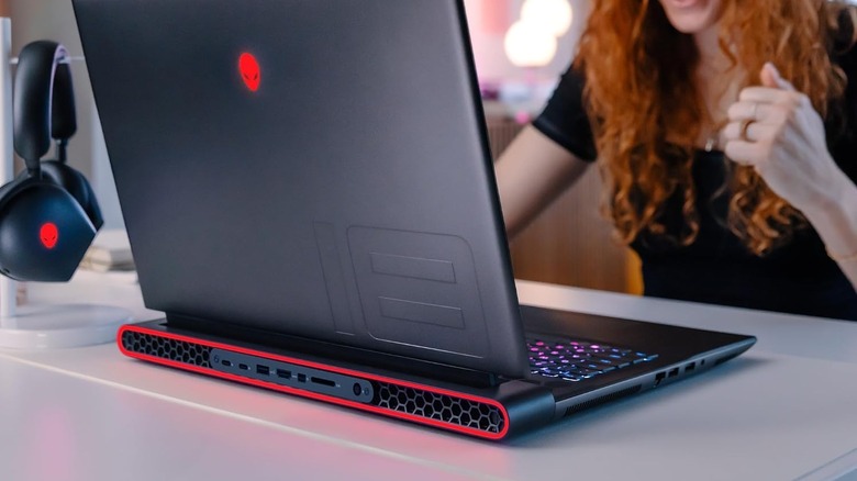 A woman using Alienware m18 laptop