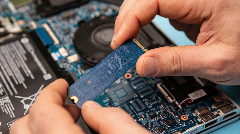 Person repairing laptop