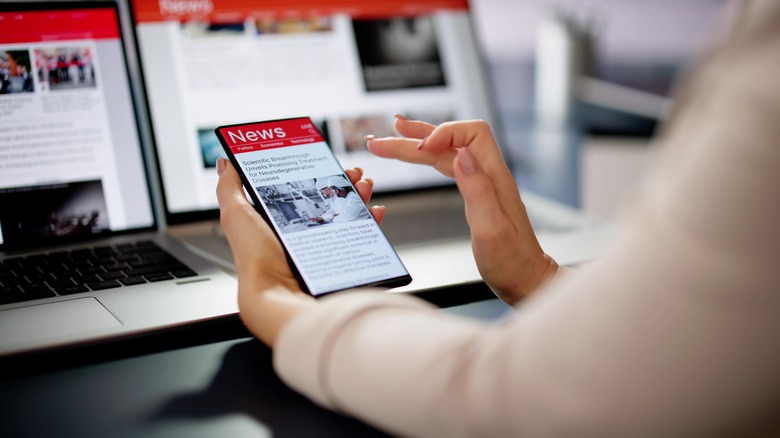 Woman looking at news on her phone