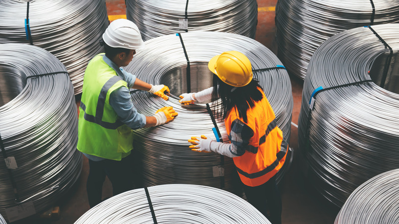 engineering man and women working with steel