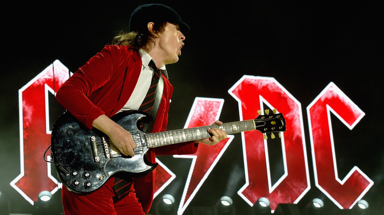 Angus Young playing guitar on stage