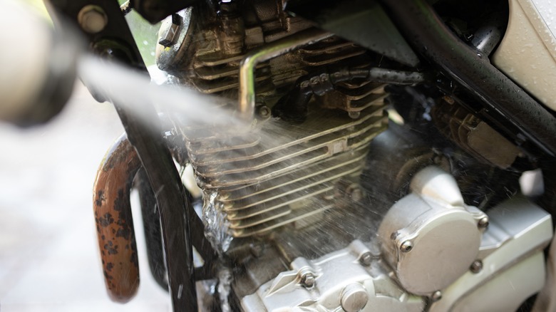 Spraying water on motorcycle engine