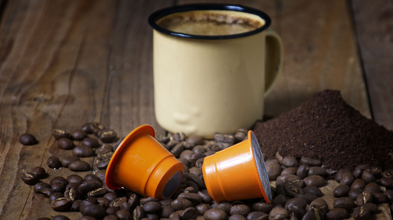 Coffee pods with coffee beans and grounds on display