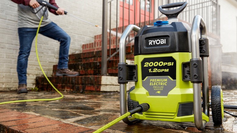 Man cleaning steps with Ryobi pressure washer