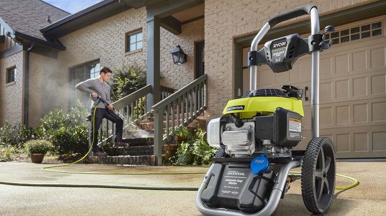 Man cleaning steps with Ryobi pressure washer