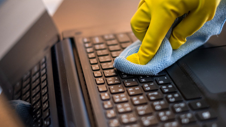 cleaning laptop with cloth