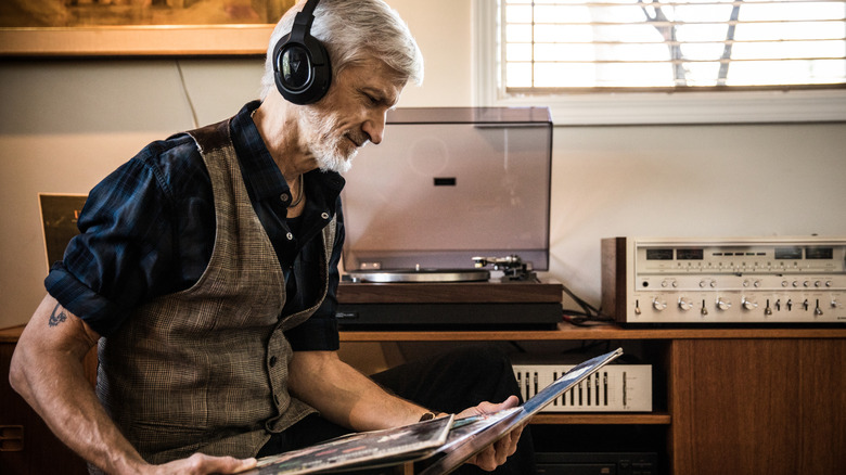 Man playing records at home