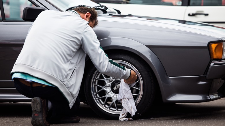 Man polishing alloy wheels