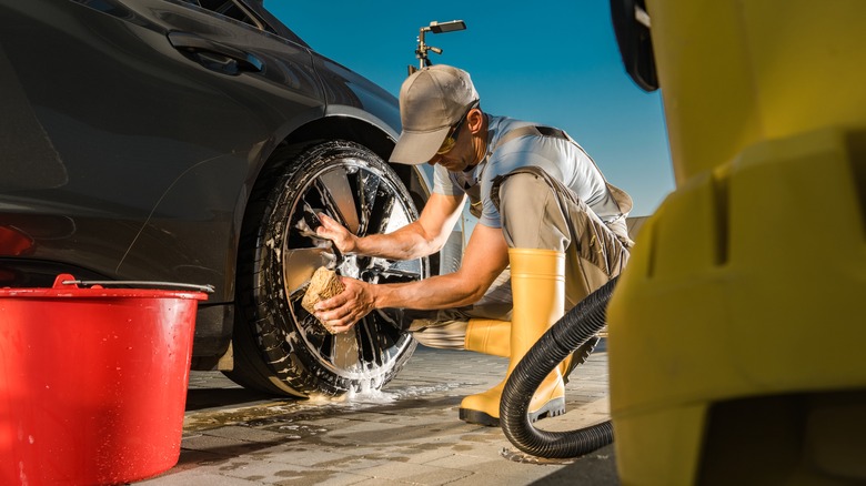 Person washing alloy wheel