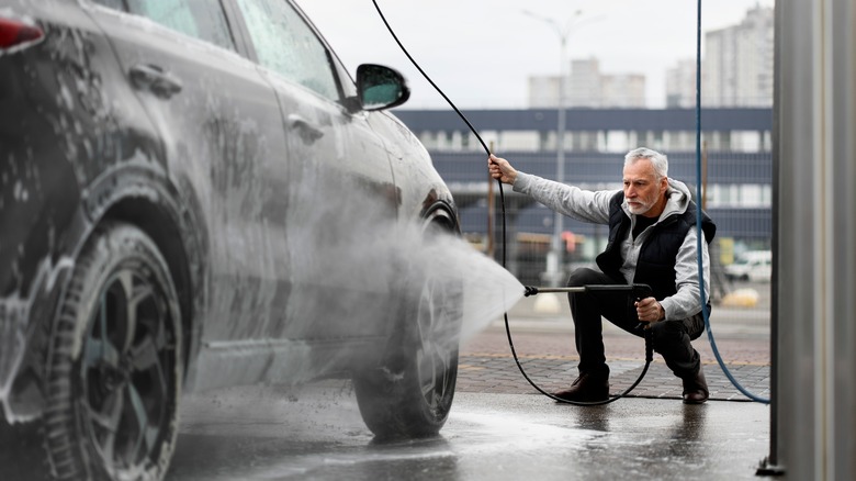 man cleaning car