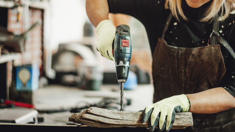 person using electric drill